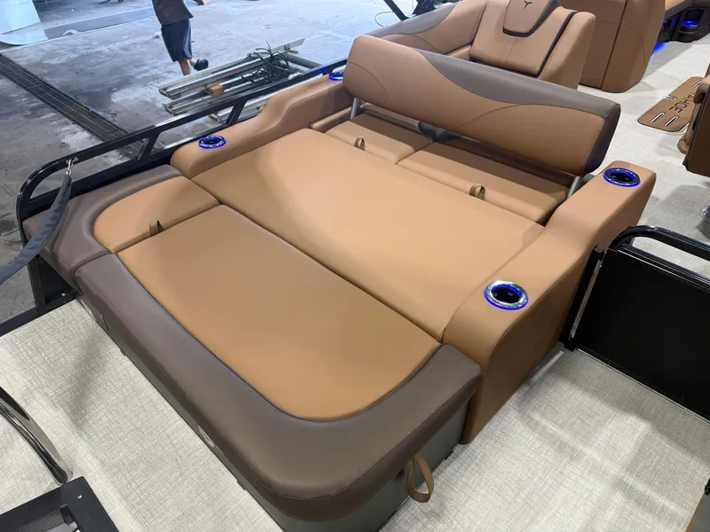 Slide: The Image of Luxurious beige and brown lounge area on a modern boat with blue cup holders. - 20