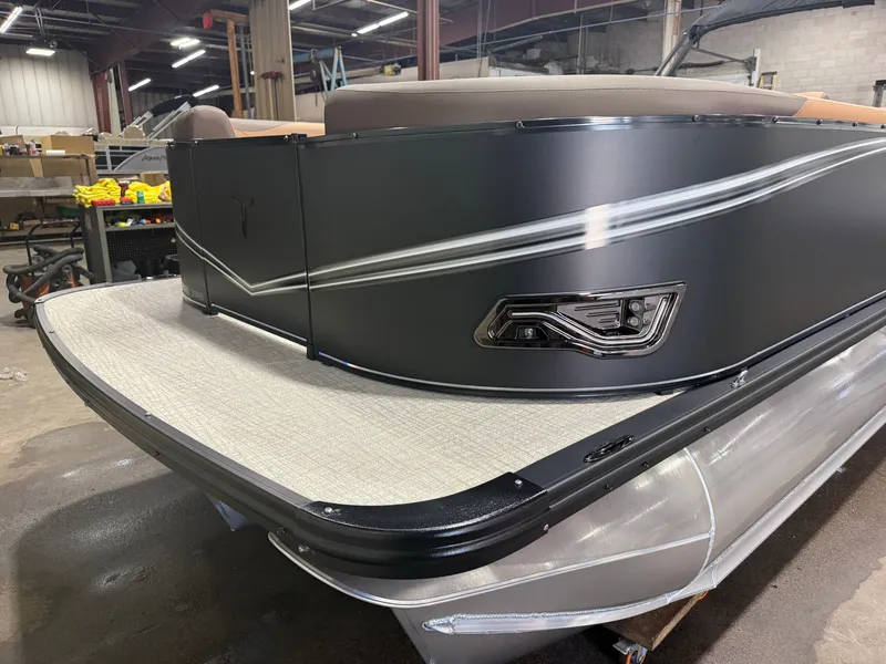 Slide: The Image of A modern tritoon with sleek lines and sturdy construction in a warehouse setting. - 37