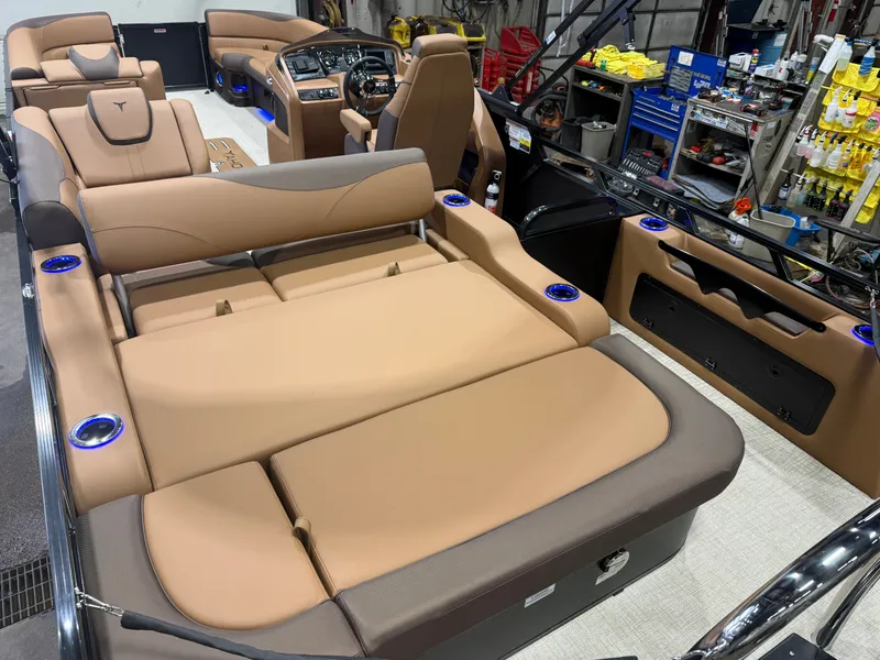 Slide: The Image of The image shows the interior of a modern pontoon boat with luxurious beige seating and blue cup holders. - 21