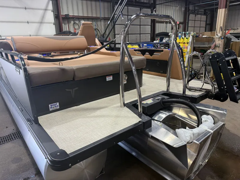 Slide: The Image of A modern tritoon with beige seating and stainless steel railings in a warehouse. - 43