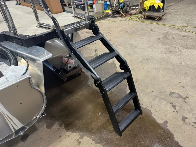 Slide: The Image of A black ladder leads to a boat dock. The floor is wet and there are tools in the background. - 48