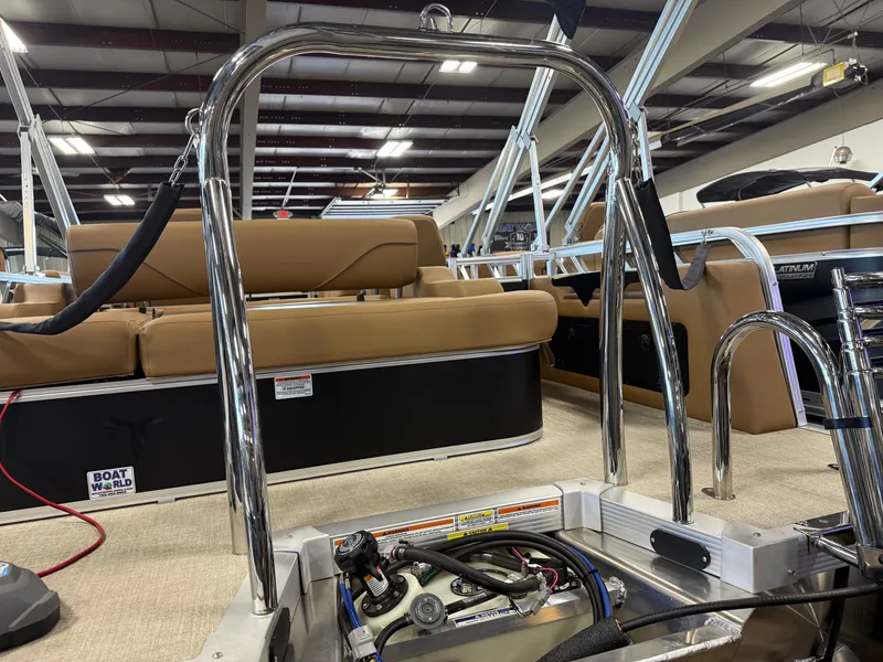 Slide: The Image of The image shows the interior of a modern pontoon boat with beige seating and stainless steel railings. - 36