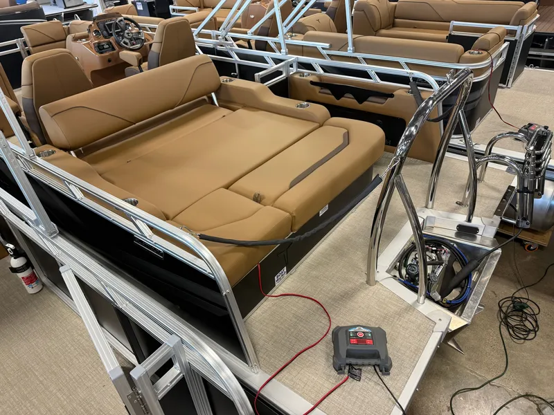 Slide: The Image of The image shows the interior of a modern pontoon boat with brown seating and a helm station. - 4