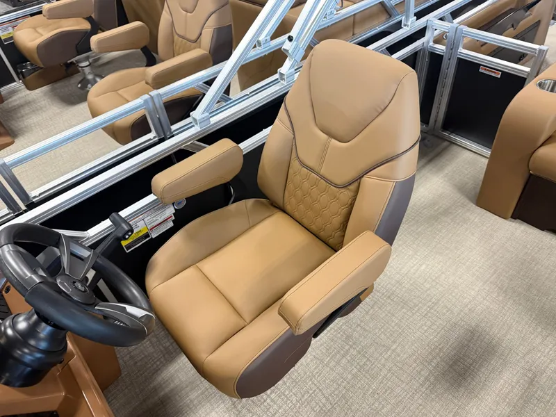 Slide: The Image of A luxurious, padded captain's chair with armrests and steering wheel in a modern boat. - 12