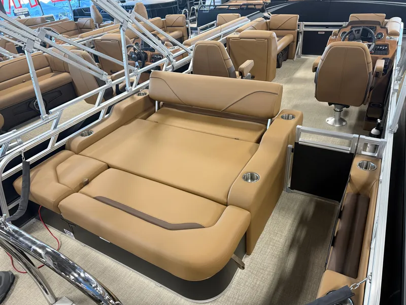 Slide: The Image of The image shows the interior of a modern pontoon boat with beige leather seats and stainless steel railings. - 22