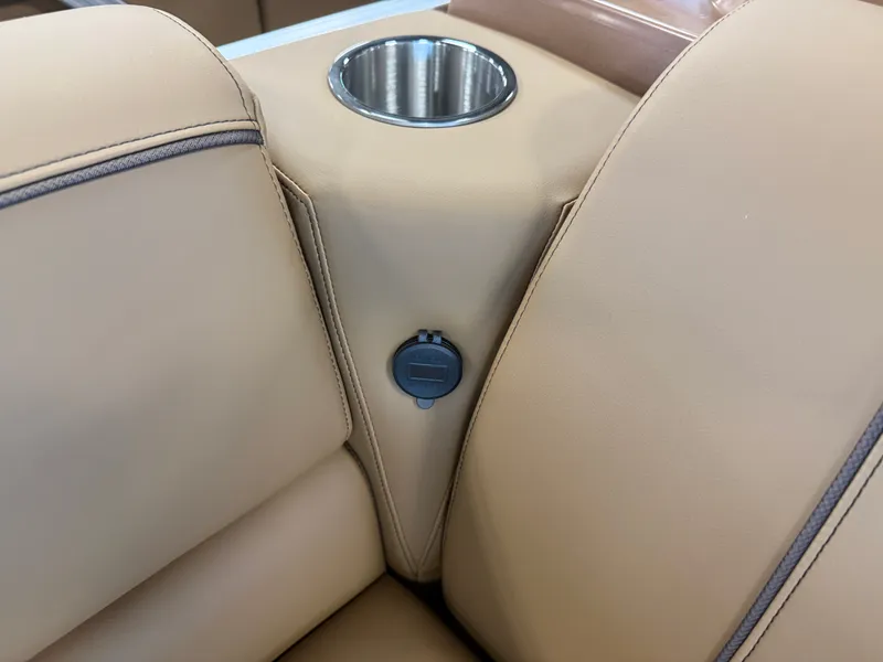 Slide: The Image of Close-up of beige leather seats with a built-in cup holder and USB port. - 28