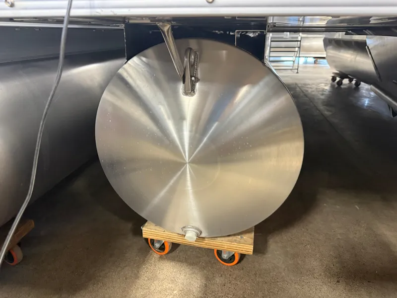 Slide: The Image of An aluminum pontoon on a wheeled cart in a warehouse. - 33