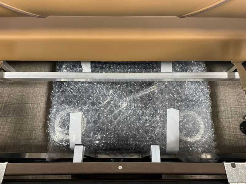 Slide: The Image of A seating area with brown upholstery and packaged items wrapped in bubble wrap underneath. - 30