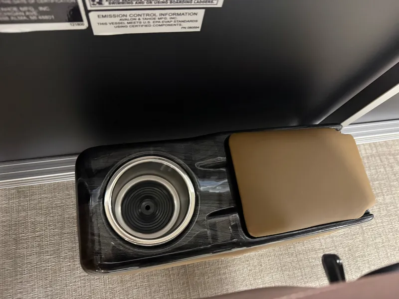 Slide: The Image of Close-up of a boat interior featuring a cup holder and a padded armrest. - 17