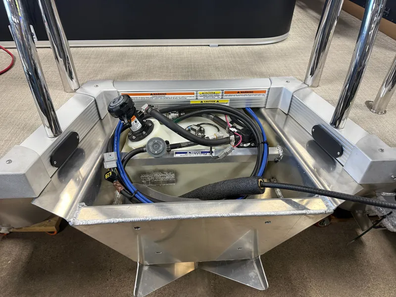 Slide: The Image of An open compartment with hoses and cables on a boat. - 34