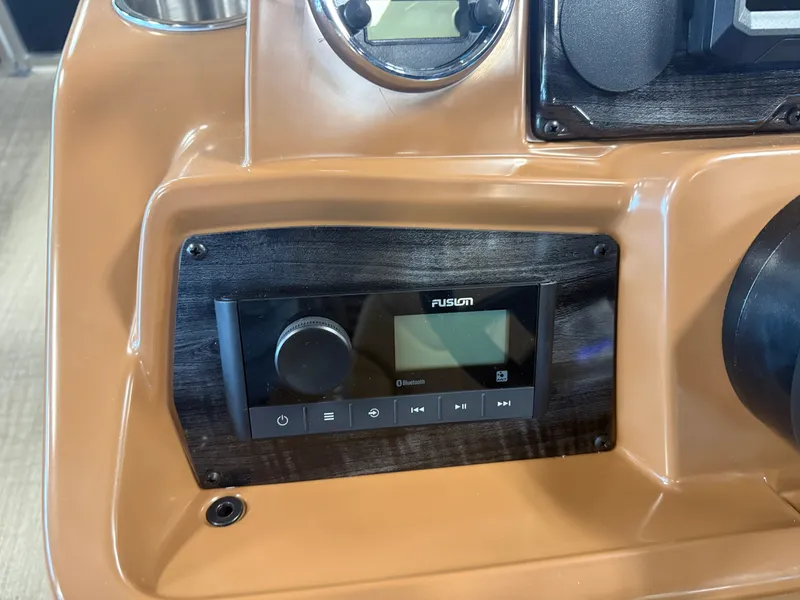 Slide: The Image of Close-up of a boat console area featuring a Fusion audio system and controls. - 14