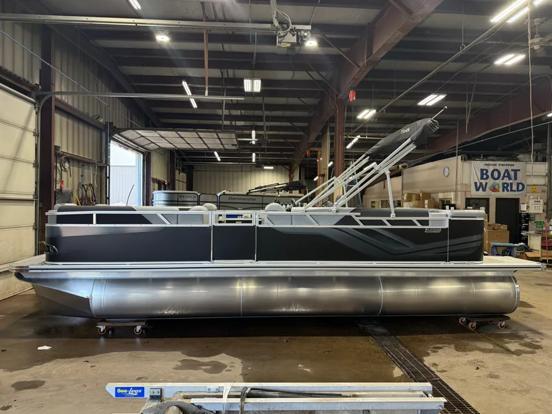 Slide: The Image of A modern pontoon boat indoors, featuring a sleek black design and sturdy aluminum hull. - 44