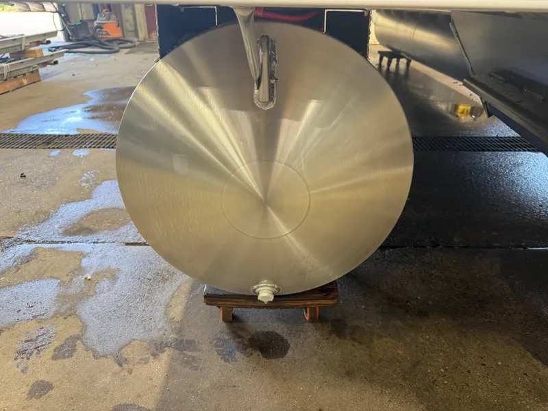 Slide: The Image of Close-up of a shiny metal propeller on a wooden block in a workshop. - 38