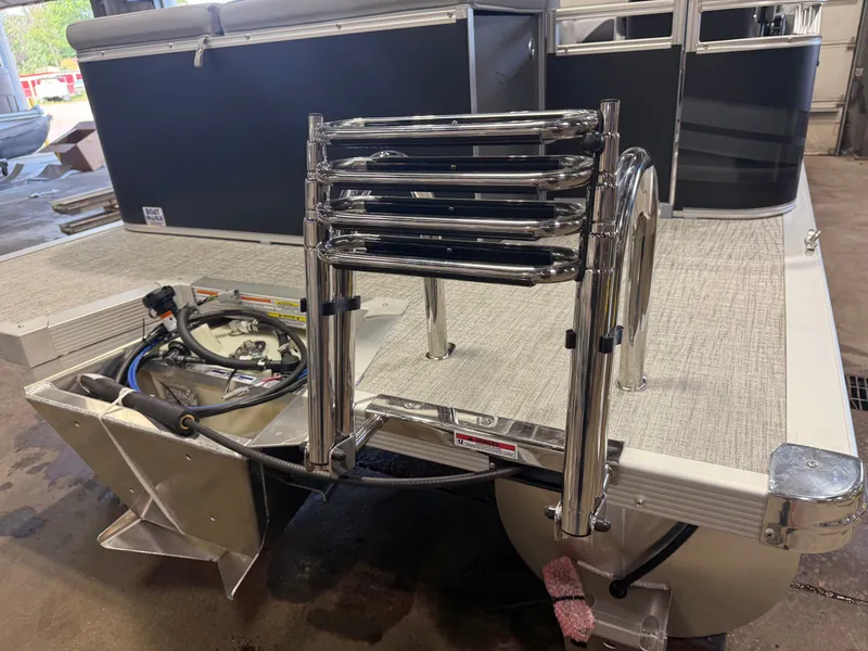 Slide: The Image of The image shows the rear of a Tahoe Sport 2180 Cruise with a swim ladder and motor. - 40