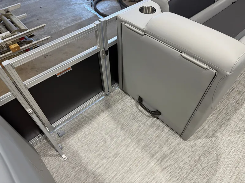 Slide: The Image of The image shows part of a boat's interior with gray upholstery and a cup holder. - 25