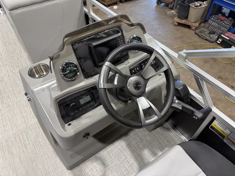 Slide: The Image of The image shows a boat's helm with a modern steering wheel and instruments. - 13