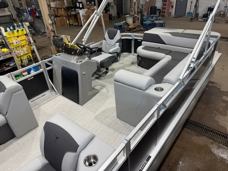 Slide: The Image of The image shows the interior of a modern pontoon boat with gray upholstery and a helm station. - 4