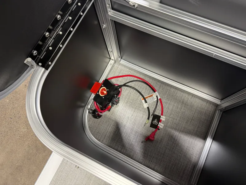 Slide: The Image of An open storage compartment with cables and a switch inside. - 23