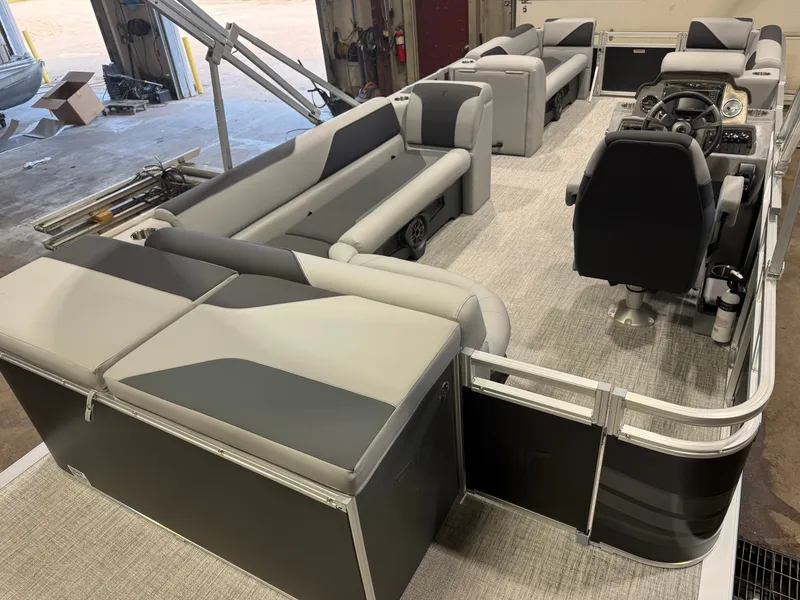 Slide: The Image of Interior view of a modern pontoon boat with gray seating and a helm station. - 21