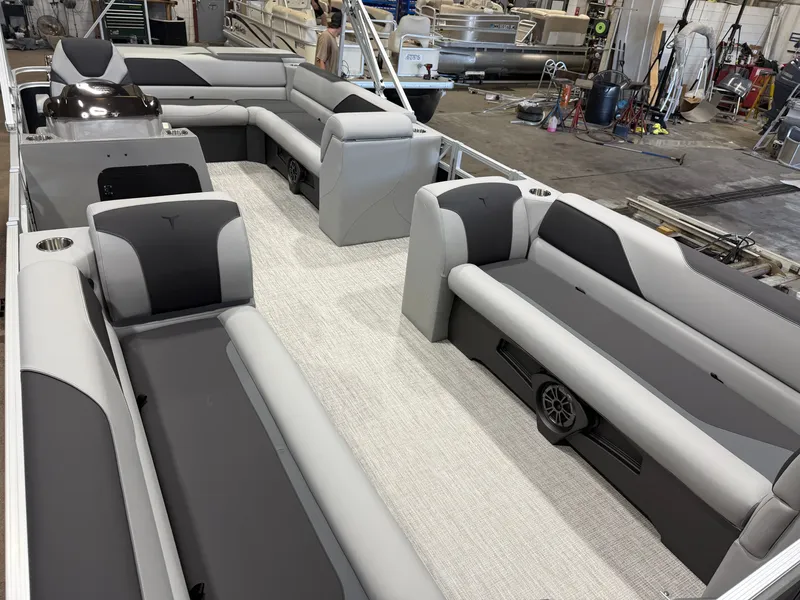 Slide: The Image of The image shows the interior of a modern pontoon boat with gray and black seating. - 31