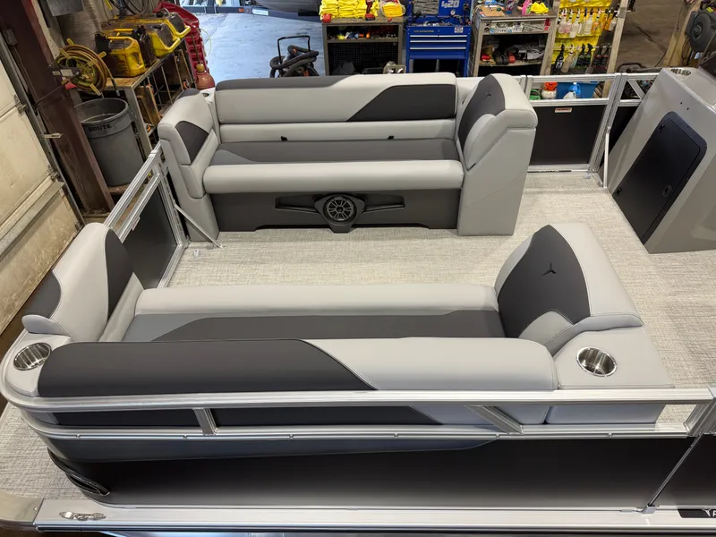 Slide: The Image of Interior view of a modern pontoon boat with gray and black seating, cup holders, and speakers. - 2