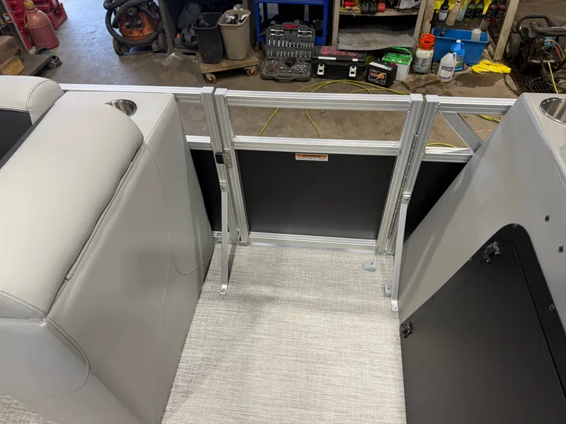 Slide: The Image of Boat interior with gray upholstery and metal railing, surrounded by workshop tools. - 27