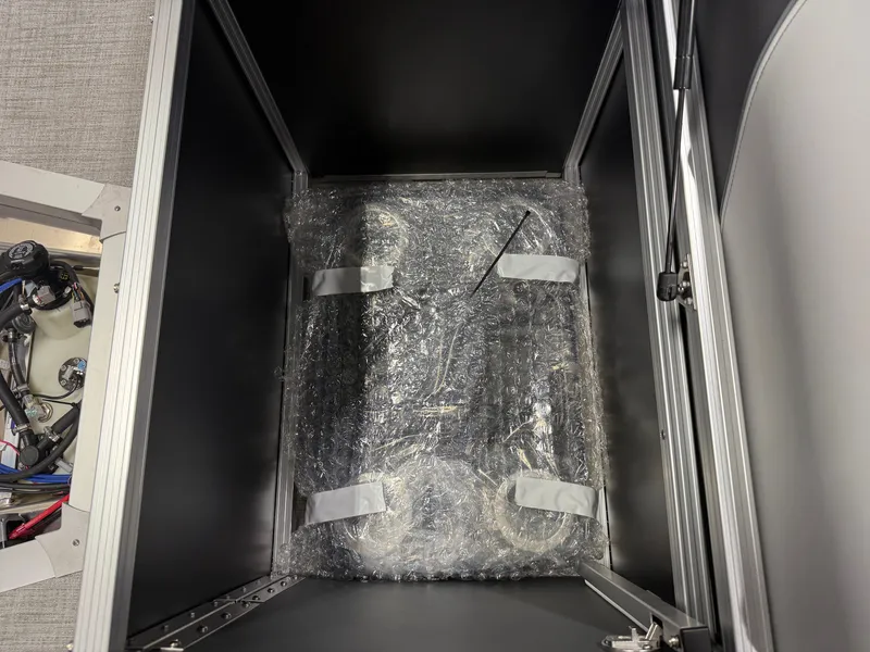Slide: The Image of A securely packaged boat part inside a cabinet with a gray interior. - 20
