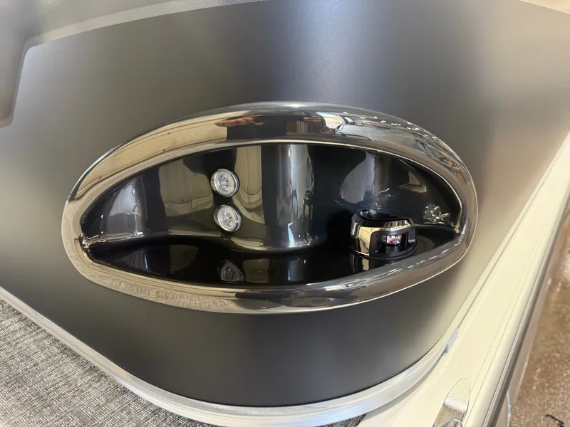 Slide: The Image of Close-up of a shiny, oval boat detail with two lights and a switch. - 33