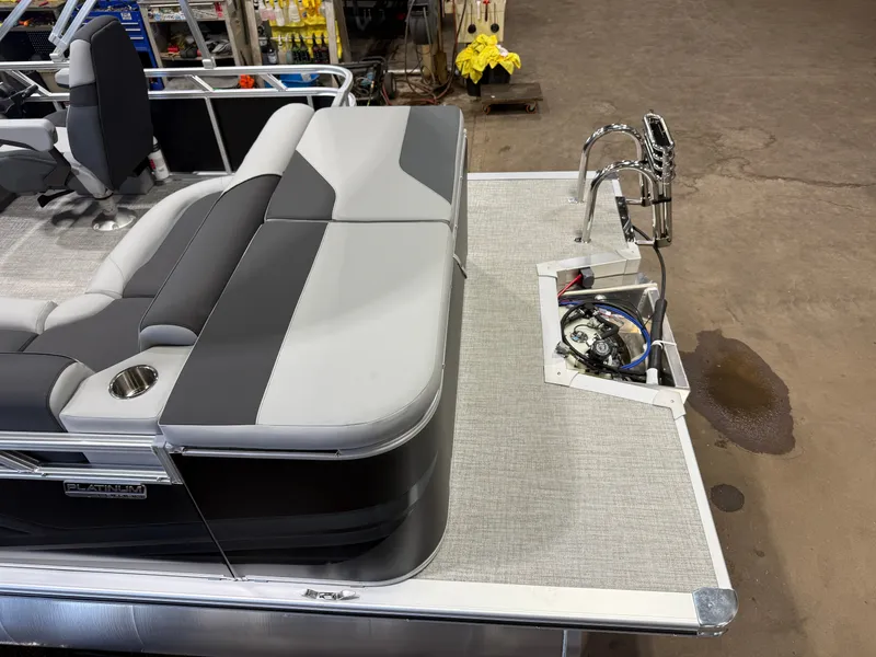 Slide: The Image of The image shows the rear of a modern pontoon boat with gray upholstery and a stainless steel motor. - 6