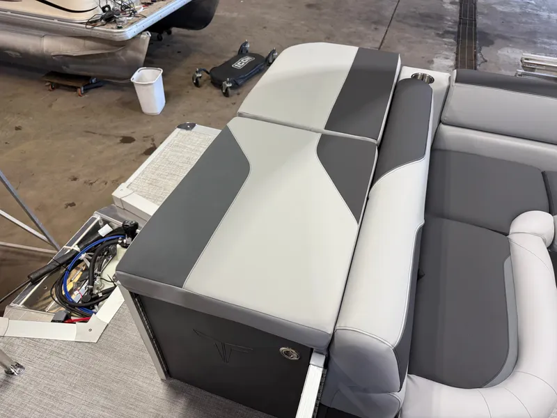 Slide: The Image of Gray and white upholstery on a boat seat in a workshop setting. - 19