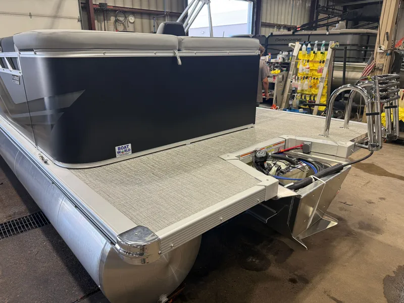 Slide: The Image of A gray pontoon boat in a workshop with a Honda 4-stroke engine. - 37