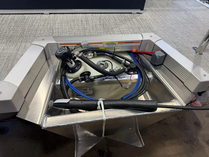 Slide: The Image of An open engine compartment with various cables and hoses, installed in a boat. - 39
