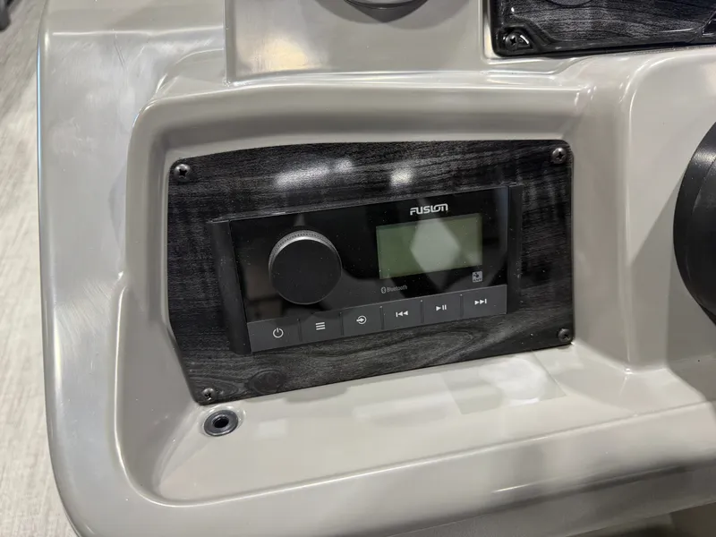 Slide: The Image of Close-up of a boat console panel featuring a Fusion audio system. - 14