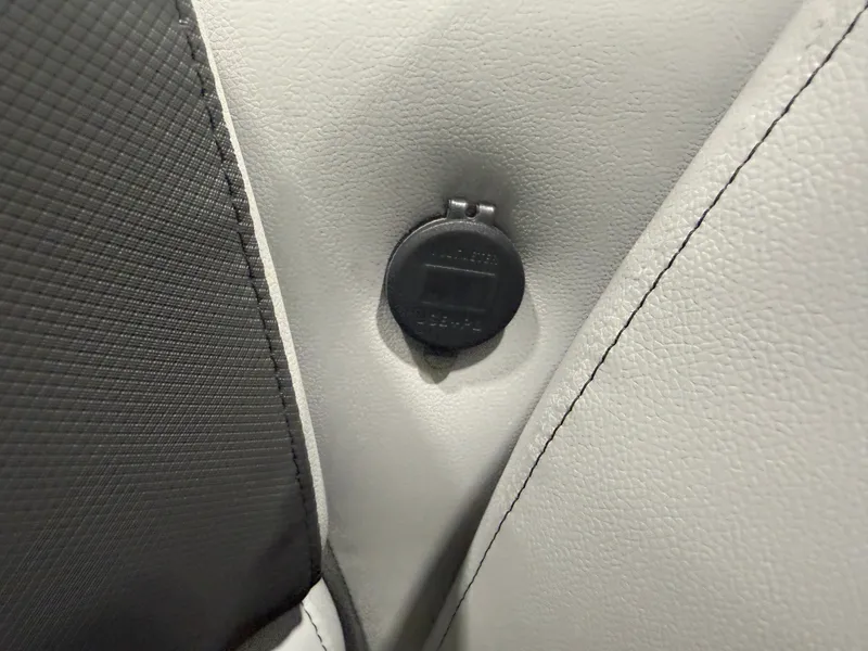 Slide: The Image of Close-up of a black socket outlet on gray upholstery. - 29