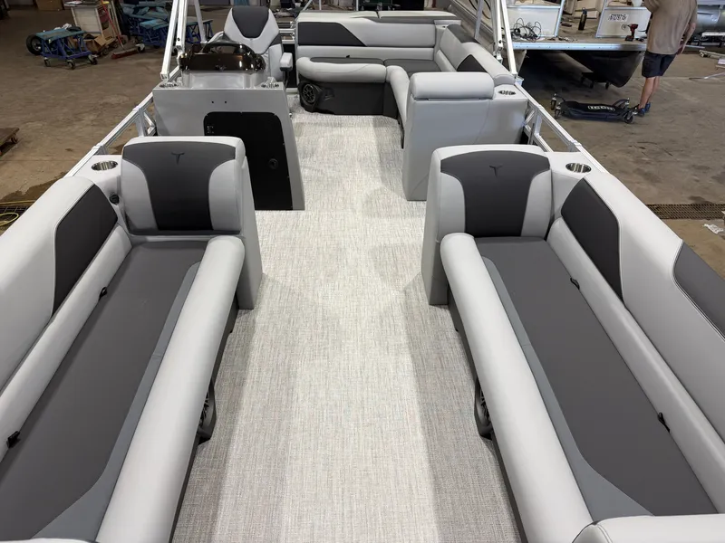 Slide: The Image of Interior of a modern pontoon boat with gray and black seating, carpeted floor, and helm console. - 8