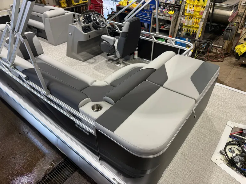 Slide: The Image of The image shows the interior of a modern pontoon boat with gray and white upholstery. - 5