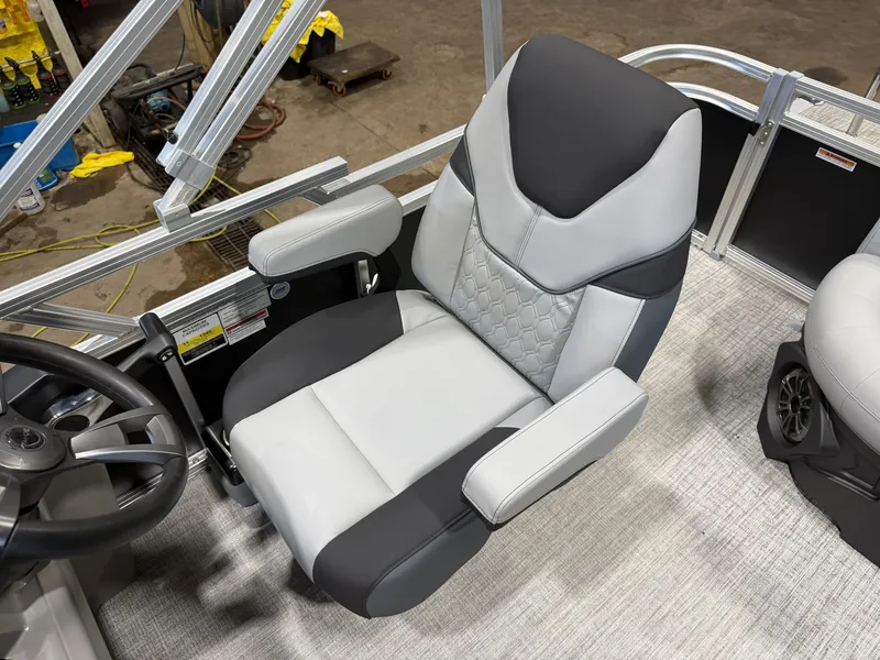 Slide: The Image of A luxurious, padded captain's chair in a modern boat with gray and black design. - 12