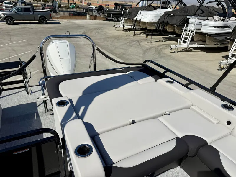Slide: The Image of The image shows the deck of an Avalon 25' LSZ VRB with comfortable lounging areas and cup holders. - 12