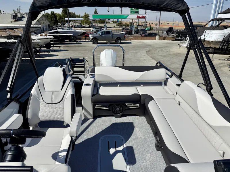 Slide: The Image of The image shows the interior of an Avalon 25' LSZ VRB with a 200HP Mercury engine. It features white and gray upholstery and a modern design. - 8
