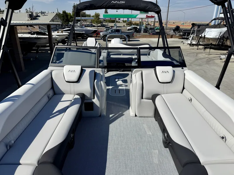 Slide: The Image of The image shows the interior of an Avalon 25' LSZ VRB boat with gray upholstery and a windshield design. - 5