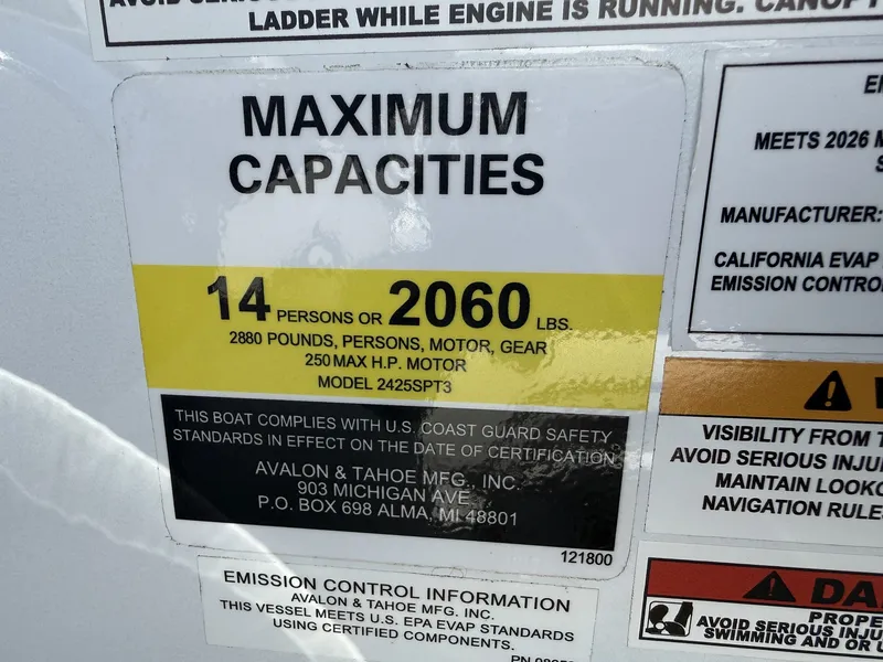 Slide: The Image of Sign shows maximum capacity: 14 persons or 2060 pounds. Includes safety and emission information. - 14