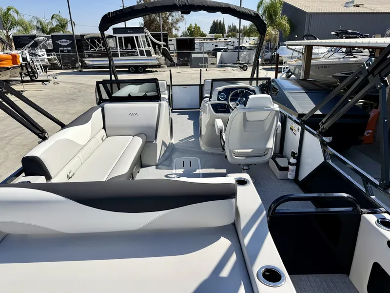 Slide: The Image of The image shows the interior of an Avalon 25' LSZ VRB boat with sleek seating and a modern helm. - 11