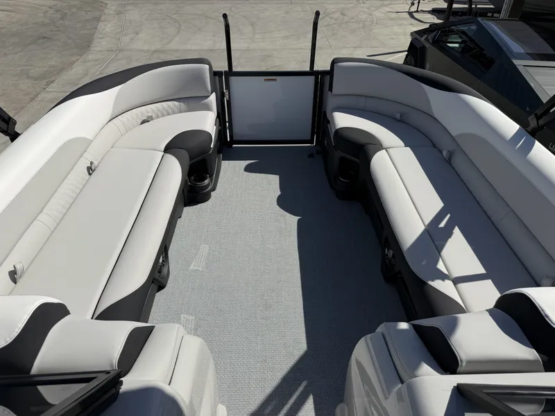 Slide: The Image of The image shows the interior of an Avalon 25' LSZ VRB with curved, cushioned seating. - 15