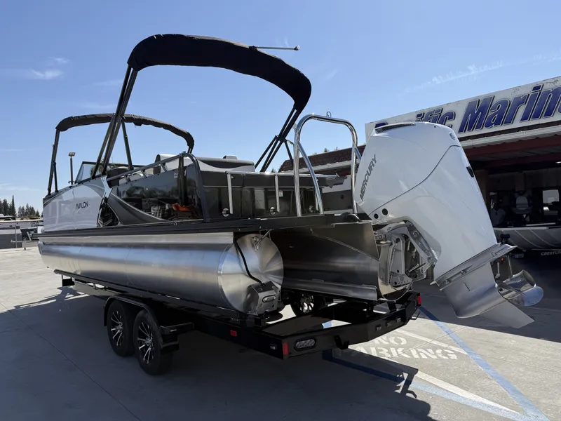 Slide: The Image of An Avalon 25' LSZ VRB pontoon boat with a 200HP Mercury engine, parked on a trailer. - 3