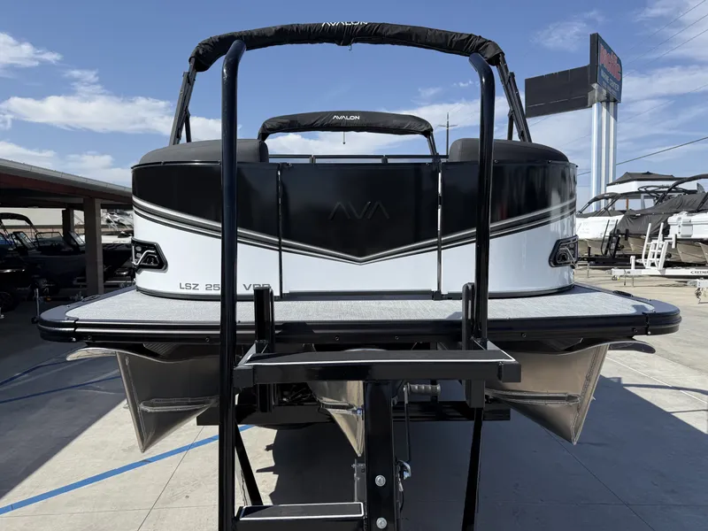 Slide: The Image of The image shows a modern Avalon 25' LSZ VRB boat with a 200HP Mercury engine. - 4