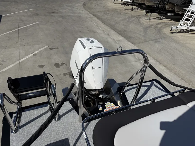 Slide: The Image of A Mercury 200HP outboard motor is attached to an Avalon 25' LSZ VRB boat on a parking lot. - 9