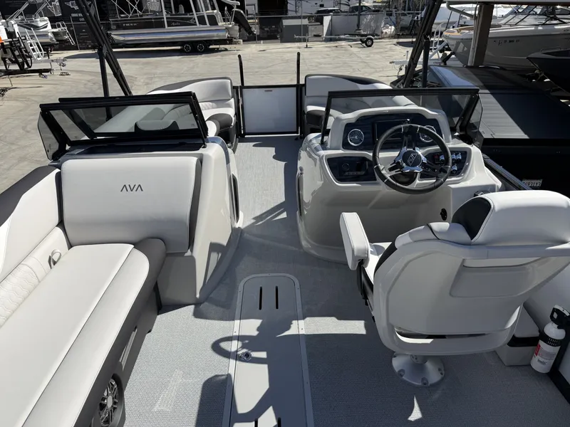 Slide: The Image of The image shows the cockpit of an Avalon 25' LSZ VRB with windshield. It features white seating and a modern helm. - 13