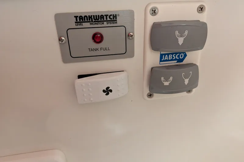 Slide: The Image of Control panel on a 2008 Back Cove 29 boat with Tankwatch system and Jabsco switches. - 35