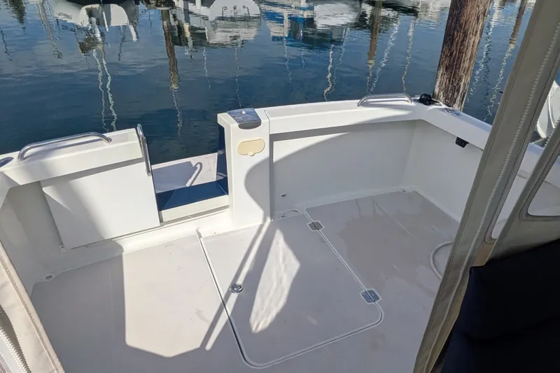 Slide: The Image of 2008 Back Cove 29 boat deck with open transom door, docked at marina. - 21