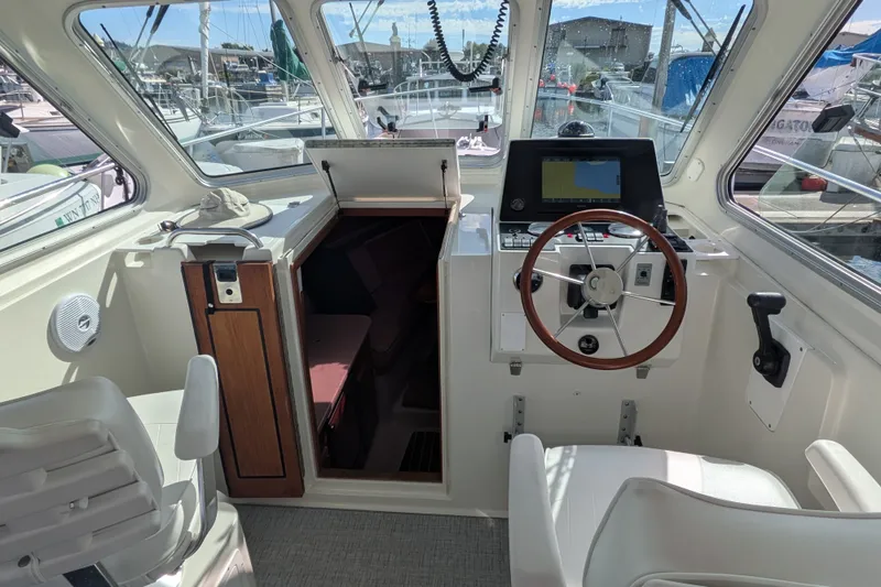 Slide: The Image of 2008 Back Cove 29 boat interior with helm, steering wheel, and navigation equipment. - 17